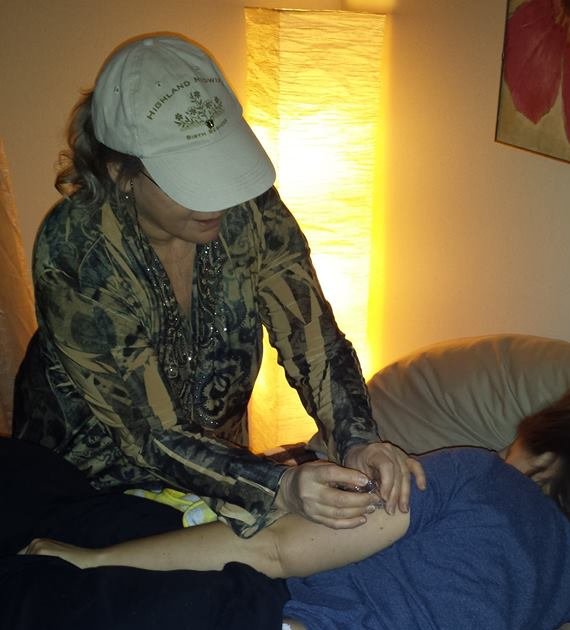 Lorri giving a postpartum RhoGam shot, home birth maternity care at Highland Midwife